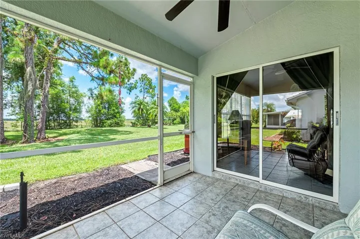 Unfurnished sunroom with vaulted ceiling and ceiling fan