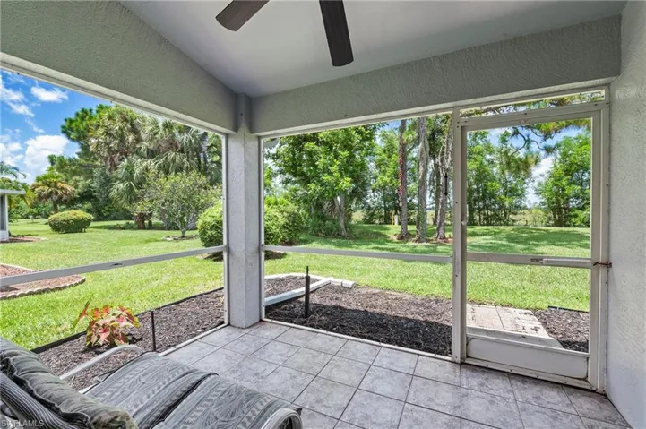 Unfurnished sunroom with ceiling fan and vaulted ceiling