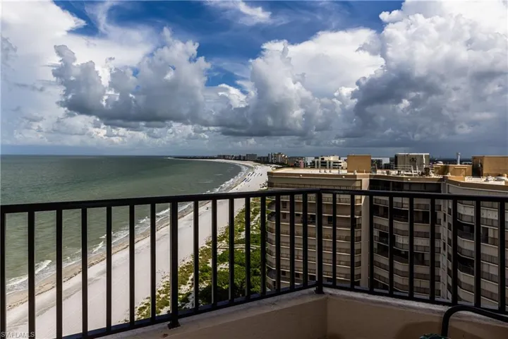 Balcony with a view of the beach and a water view