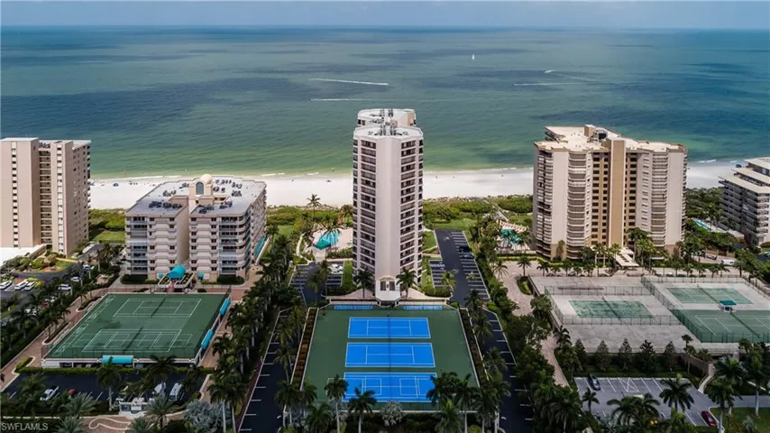 Birds eye view of property featuring a view of the beach and a water view