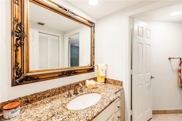Bathroom featuring tile patterned flooring and vanity