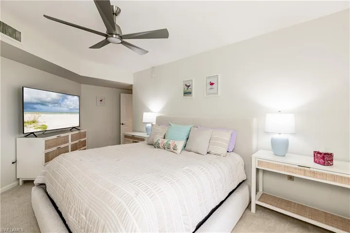 Bedroom featuring ceiling fan and light colored carpet