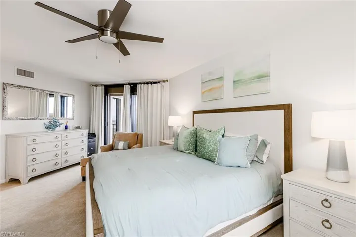 Carpeted bedroom with ceiling fan