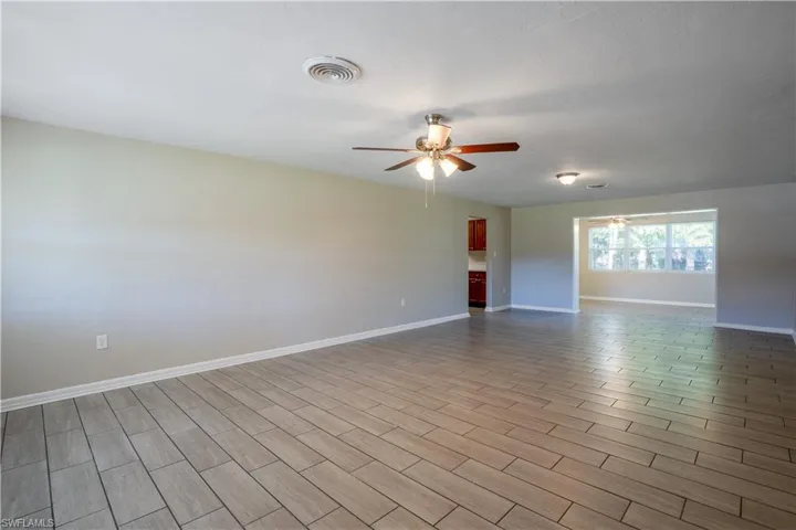 Empty room featuring wood tiled floors and ceiling fan