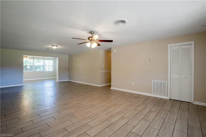 Spare room featuring a ceiling fan and wood tiled floors