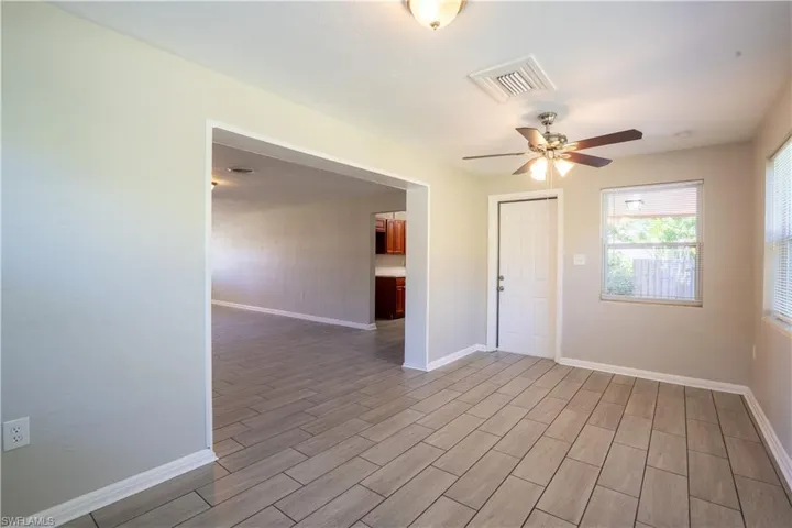 Empty room featuring wood tiled floors and a ceiling fan