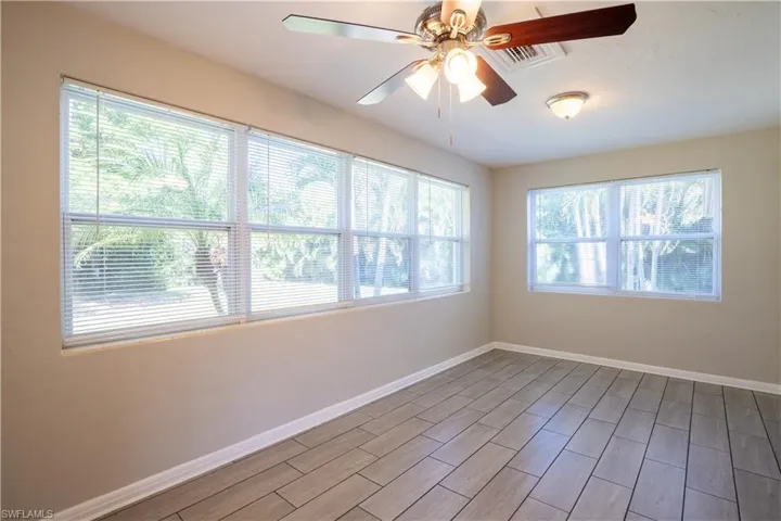 Empty room featuring ceiling fan and wood finish floors