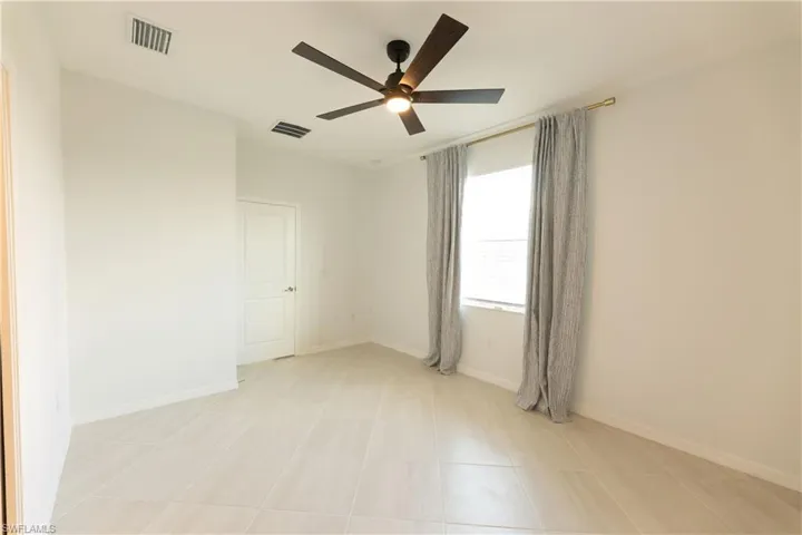 Master bedroom. featuring recessed space and view of lake