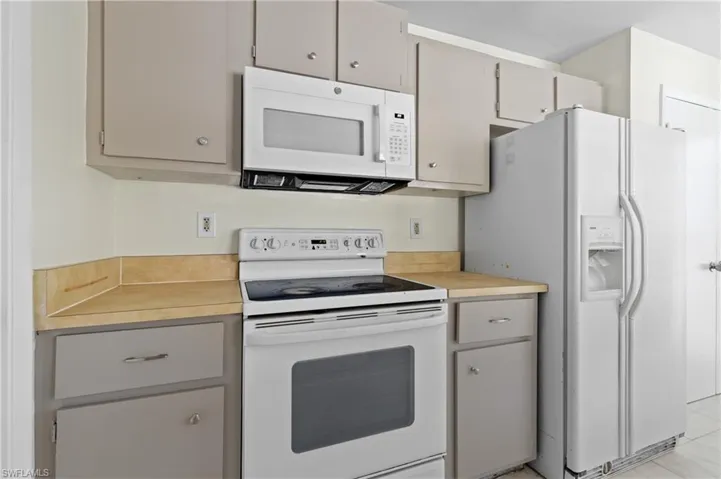 Kitchen featuring white appliances