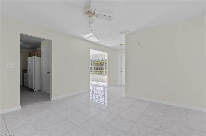 Tiled spare room with ceiling fan