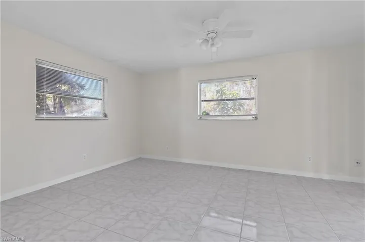 Spare room featuring plenty of natural light and ceiling fan