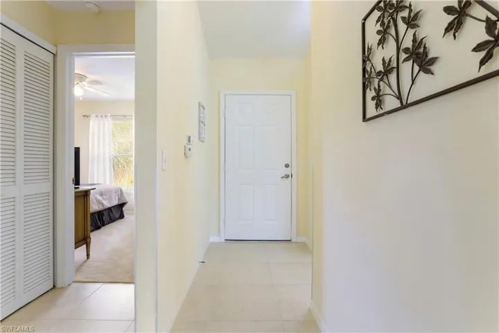 Hall with light tile patterned floors
