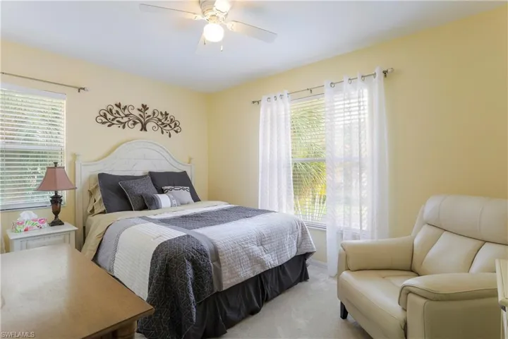 Carpeted bedroom with ceiling fan