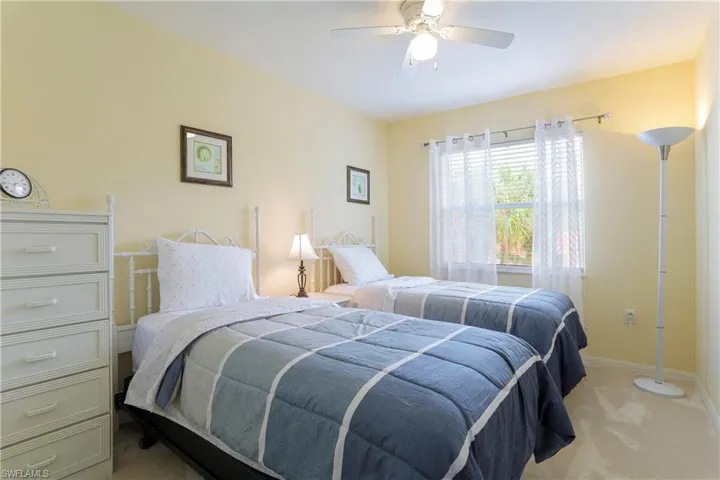 Bedroom featuring light colored carpet and ceiling fan