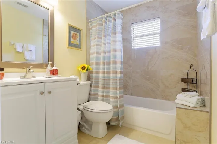 Full bathroom featuring vanity, toilet, shower / tub combo, and tile patterned floors