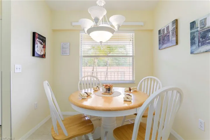 Dining room with an inviting chandelier and light hardwood / wood-style floors