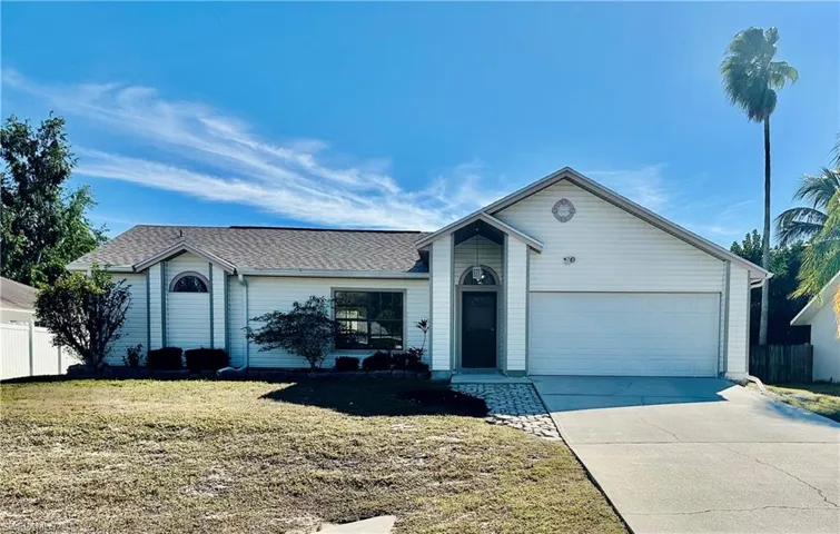 Ranch-style home featuring concrete driveway, an attached  2 car garage, and roof with shingles