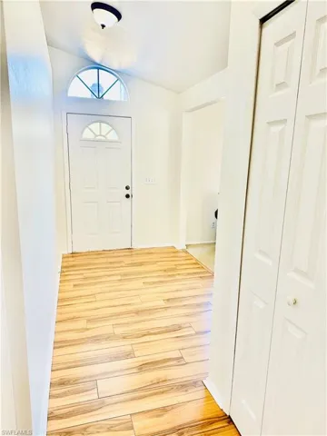 Entryway featuring light laminate flooring