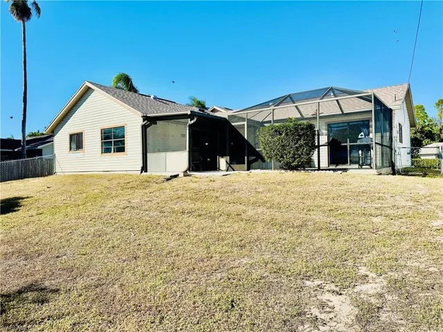 Rear view of property featuring a lanai, and a sunroom.