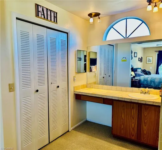 Ensuite bathroom featuring a closet, vanity which is separate from shower/toilet room.