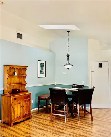 Dining area featuring vaulted ceiling