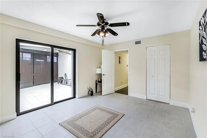 Unfurnished room with ceiling fan and light tile patterned floors