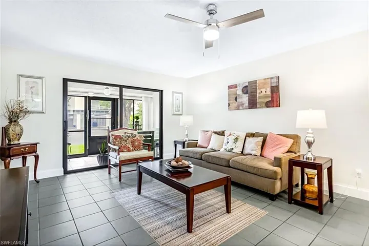 Living room featuring ceiling fan and tile patterned flooring