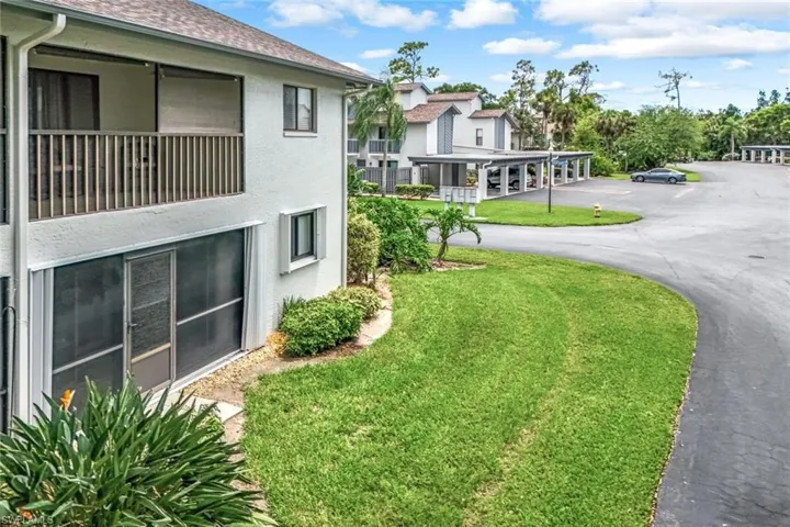 View of property's community with a lawn