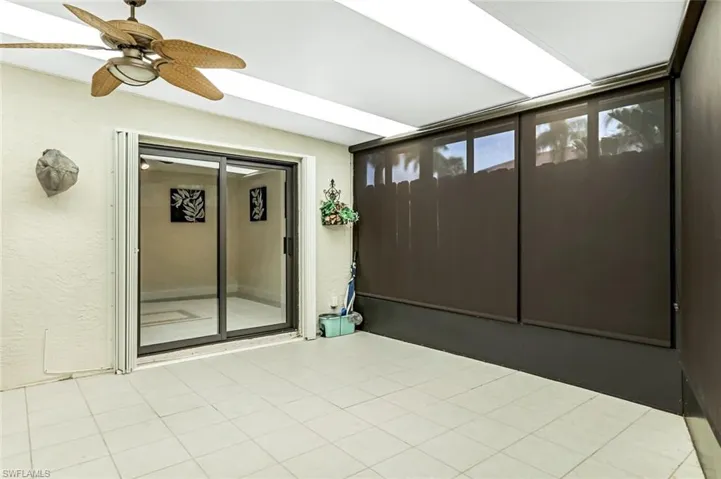 Unfurnished sunroom with ceiling fan