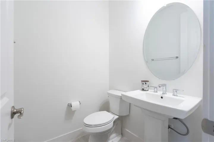 Bathroom with toilet and baseboards