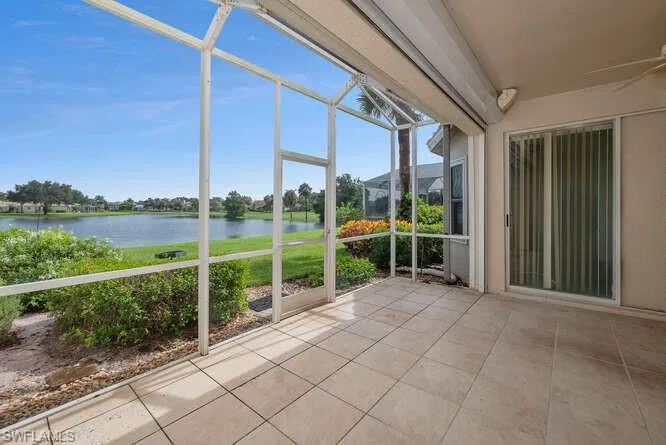 Unfurnished sunroom with a healthy amount of sunlight and a water view