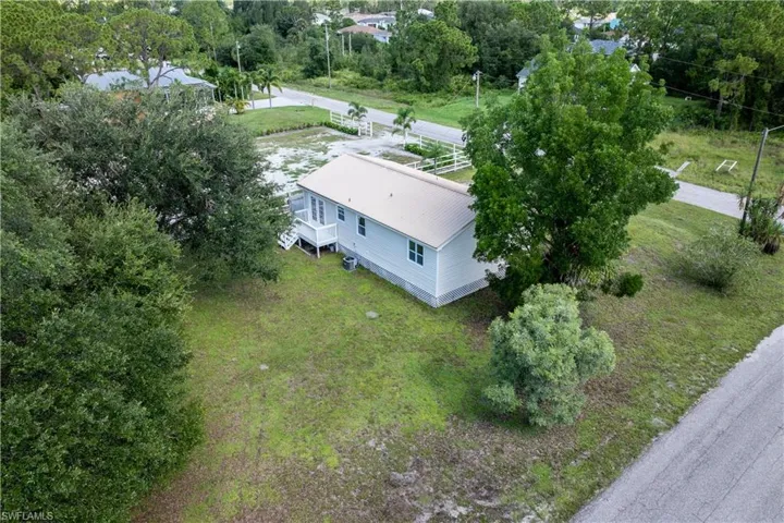 View from above of property with a tree filled landscape
