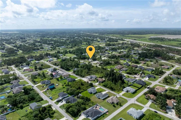 Aerial overview of property's location featuring nearby suburban area