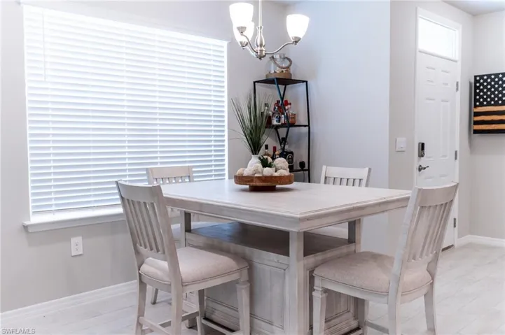 Dining area with light hardwood / wood-style flooring and a chandelier