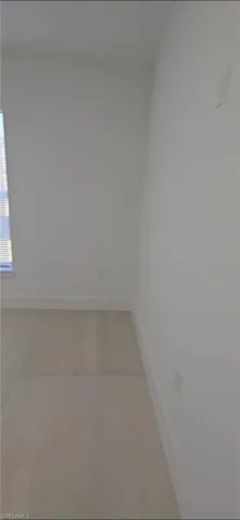 Spare room featuring baseboards