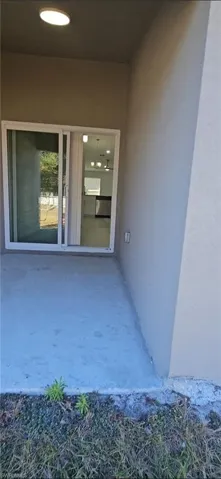Entrance to property featuring stucco siding and a patio area