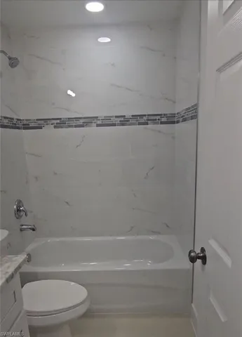 Bathroom featuring  shower combination and vanity
