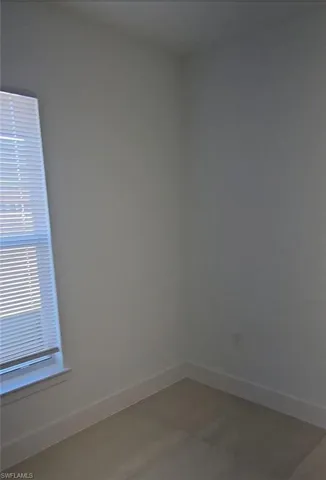 Spare room featuring baseboards