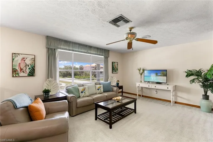 Large living room window brings in natural light.