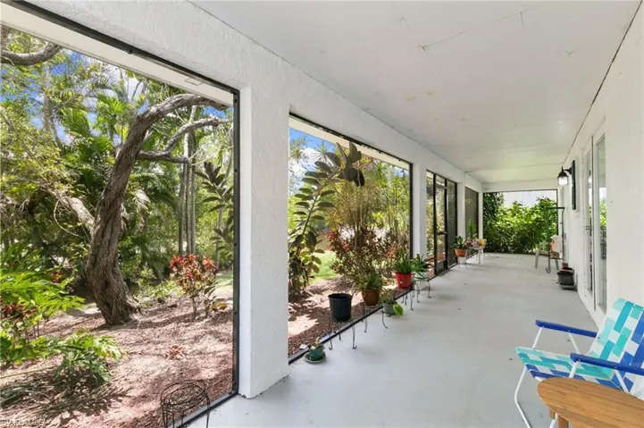 Screened ground level patio with view of pond