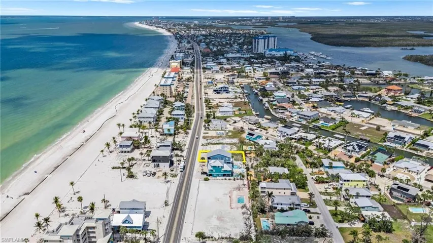 Aerial view with a view of the beach, a residential view, and a water view  - Virtually Edited Image