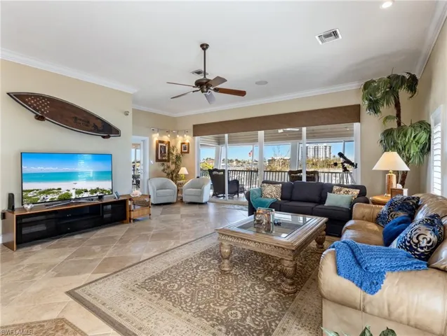 Great Room with a wall of sliders to the screened lanai, plus another doorway to the outdoor dining area