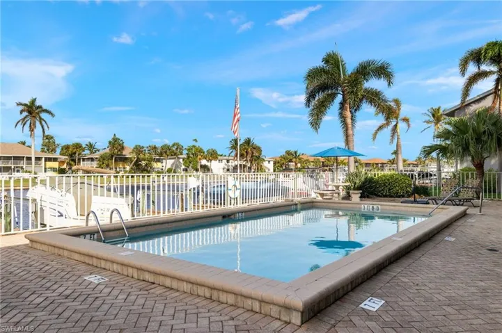 Community pool with a patio and a residential view
