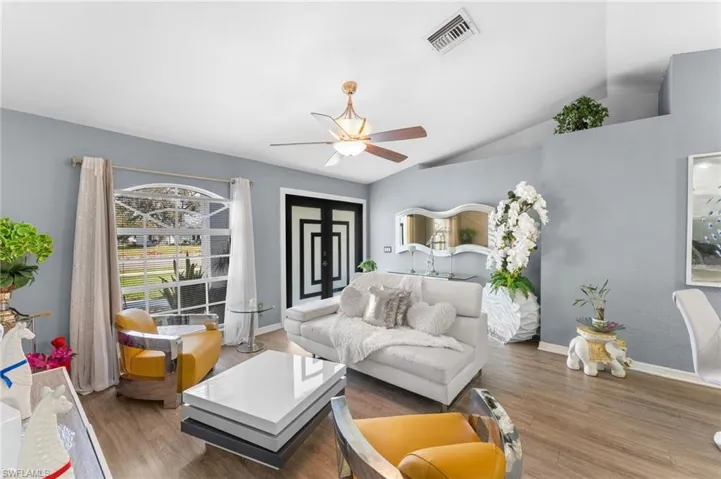 Bedroom featuring vaulted ceiling, ceiling fan, and wood-type flooring