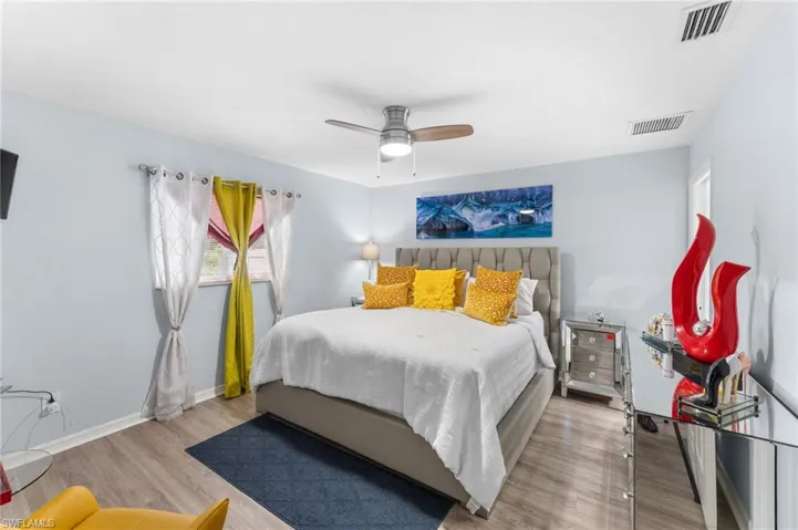Bedroom with ceiling fan and light hardwood / wood-style floors