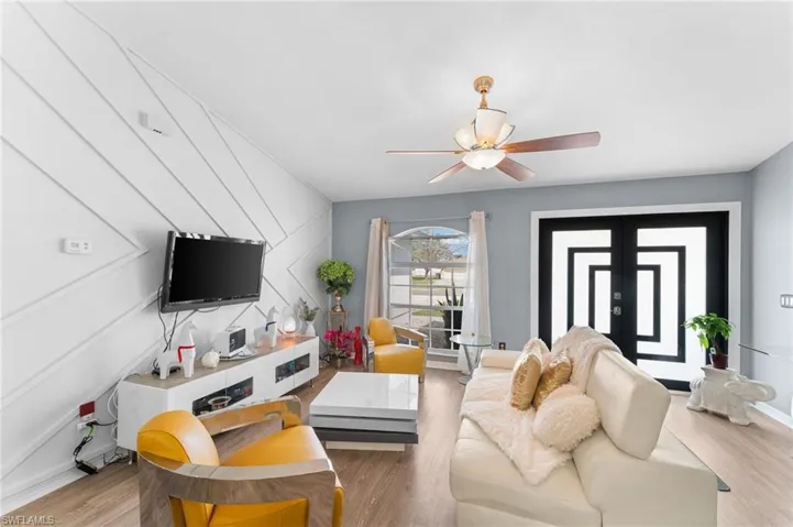 Living room featuring french doors, hardwood / wood-style flooring, and ceiling fan
