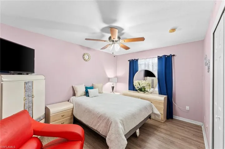 Bedroom featuring wood-type flooring and ceiling fan