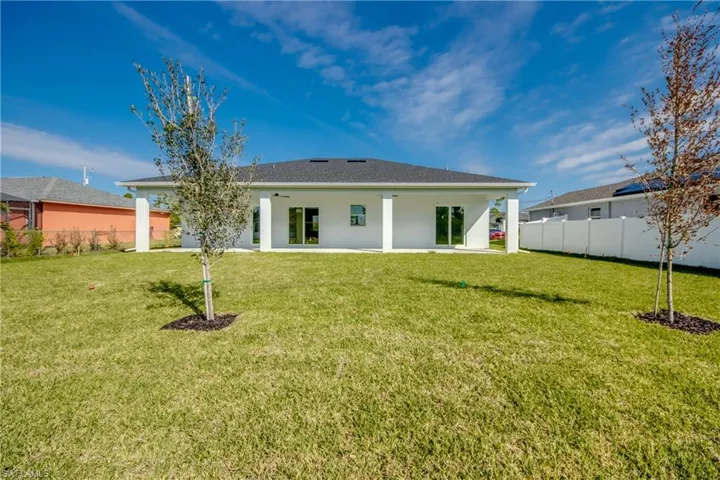 Rear view of house with a patio area and stucco siding