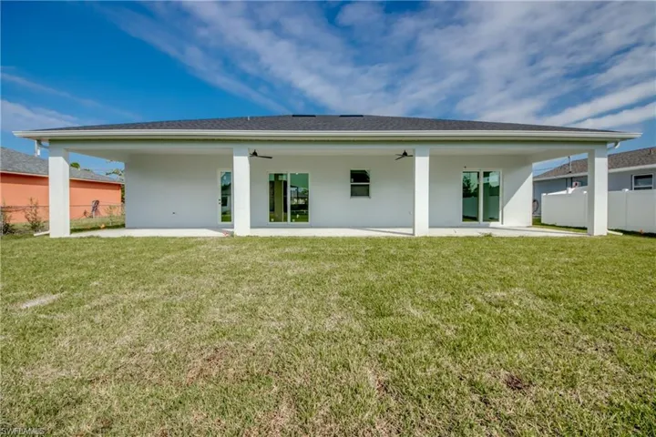 Back of house featuring a patio, stucco siding, and ceiling fan