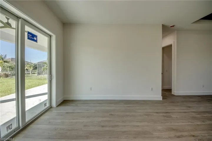 Unfurnished room with light wood-type flooring and baseboards